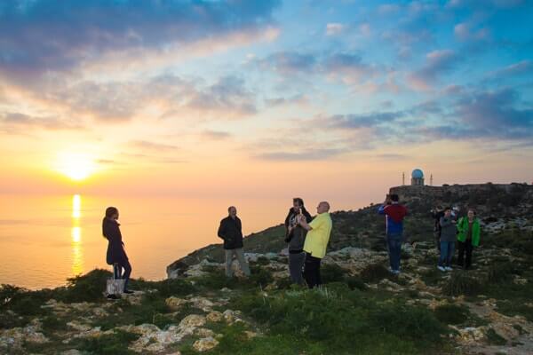 Students watching a winter sunset at Dingli Cliffs.